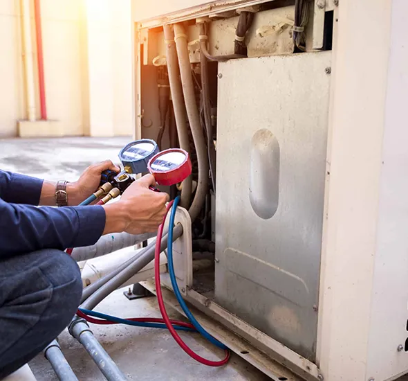 Expert technician using diagnostic tools to check the heating unit for any issues.